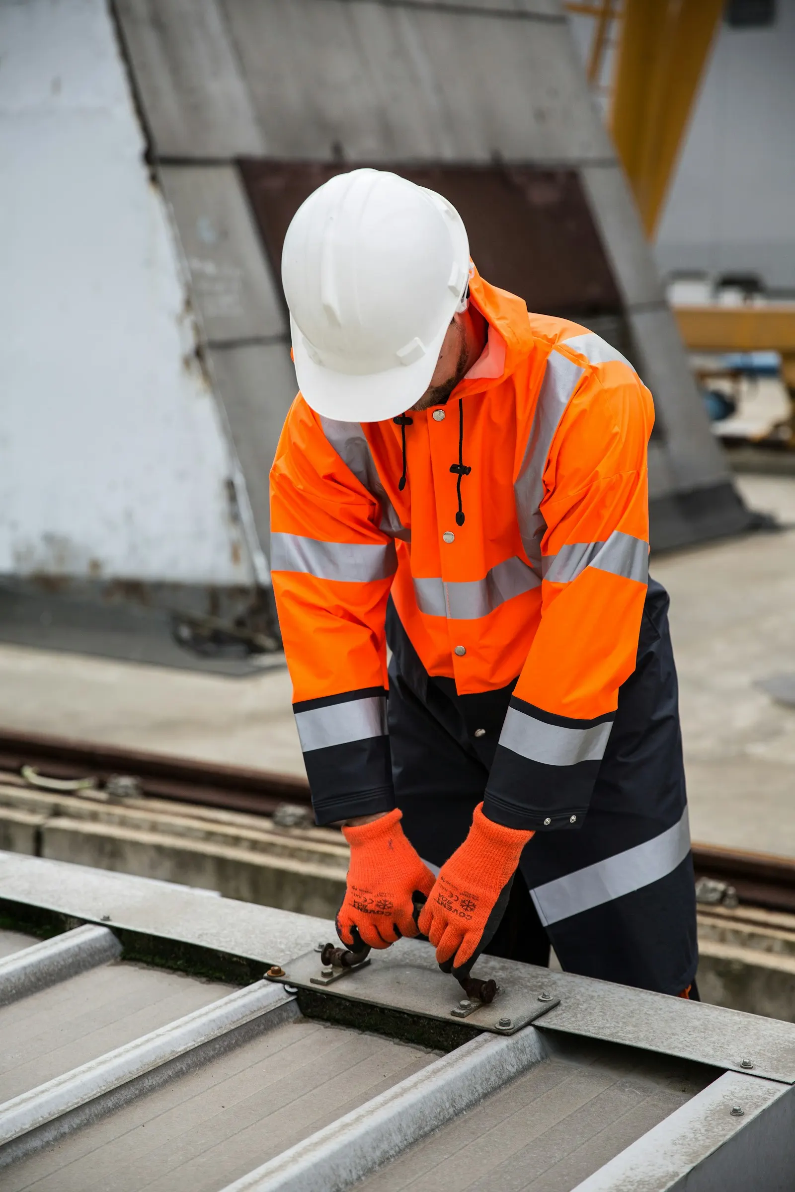 An industrial worker in high-visibility gear